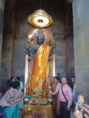 Hindu Entering Angkor Wat with Gifts Decorated Hindu entering Angkor Wat in Cambodia, welcomed by gift presenters