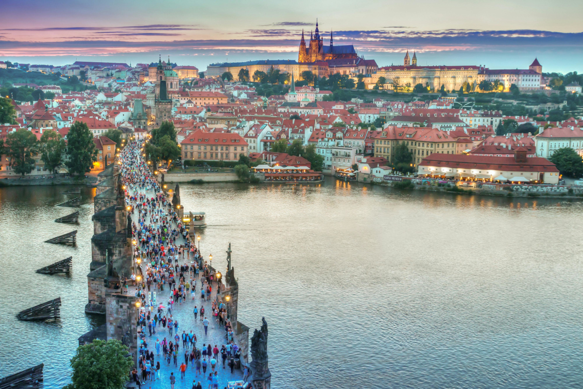 Panoramic view from Charles Bridge showing the bustling scene with Prague Castle and Lesser Town