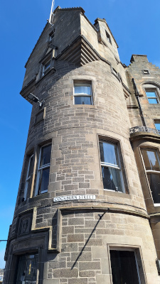 Close-up of the building leading to Cockburn Street featuring the Cockburn Street sign