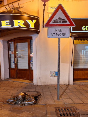 Man at work with signpost, Bratislava. Man at work with signpost, Bratislava. Whimsical statue next to Burger King