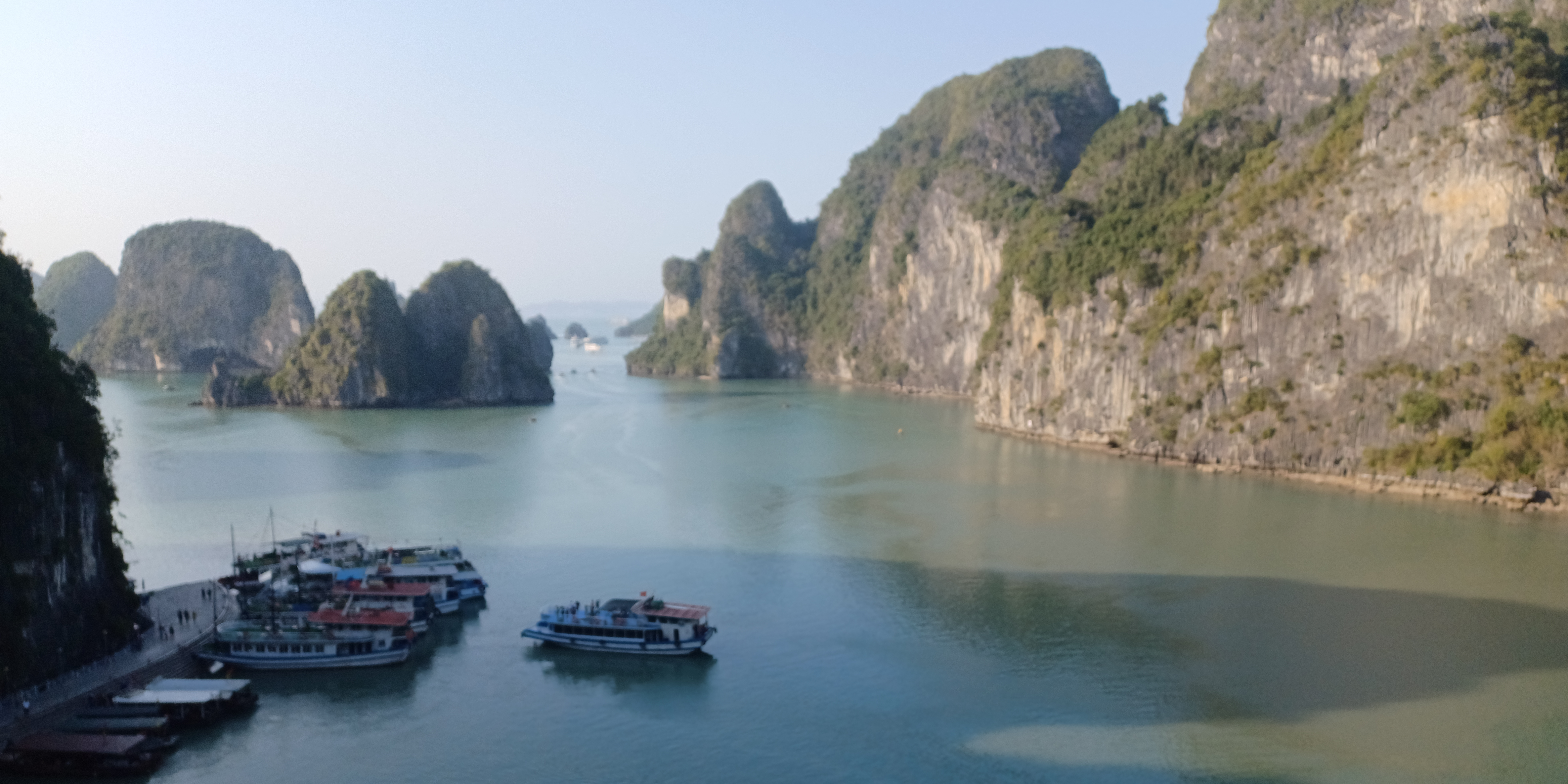 Boats docked on clear waters of Ha Long Bay from the top of Tip Top Island