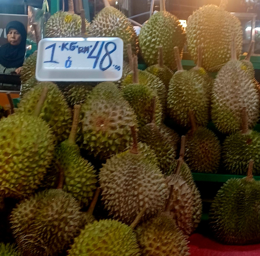 Nighttime photo of a stall in Chinatown, Kuala Lumpur, featuring fresh durian fruit