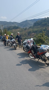 Riders Resting by Parked Bikes – Scenic View on Ha Giang Loop, North Vietnam Bikes parked at the roadside with riders resting and enjoying the view on the Ha Giang Loop, North Vietnam