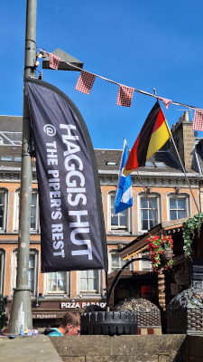 Sign for the Haggis Hut pop-up during the Fringe Festival, colorful and eye-catching