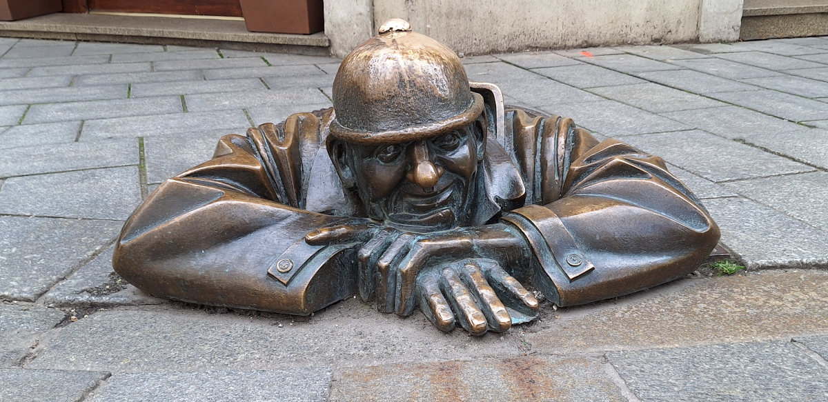 Cumil – The Man at the Manhole in Bratislava Cumil staue, which depicts a man peeking out from a manhole cover.