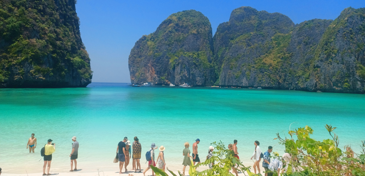 Maya Bay, Phi Phi Leh – Paradise in Thailand Sea. Blue waters surrounded by limestone karsts and blue sky.