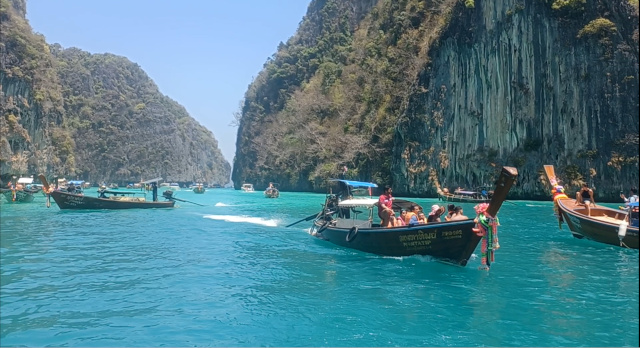 Long-Tail Boat Journey to Maya Beach – Phi Phi Leh Long-tail boat heading to Maya Beach, Phi Phi Leh