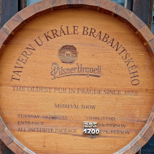 Wine barrel used as a sign advertising the oldest pub in the Prague Castle distric