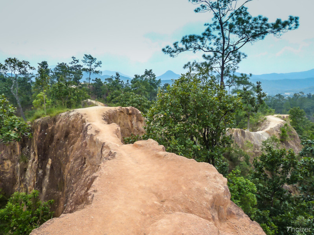 Narrow path over Pai Canyon in North Thailand, showcasing stunning views and rugged terrain