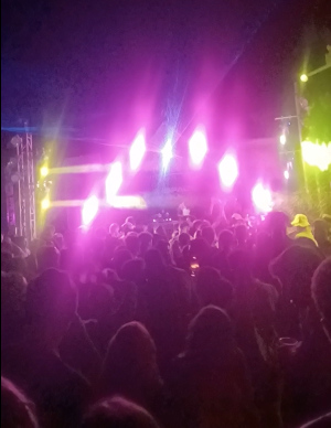 Crowd dancing at an outdoor jungle party in Pai with vibrant lights