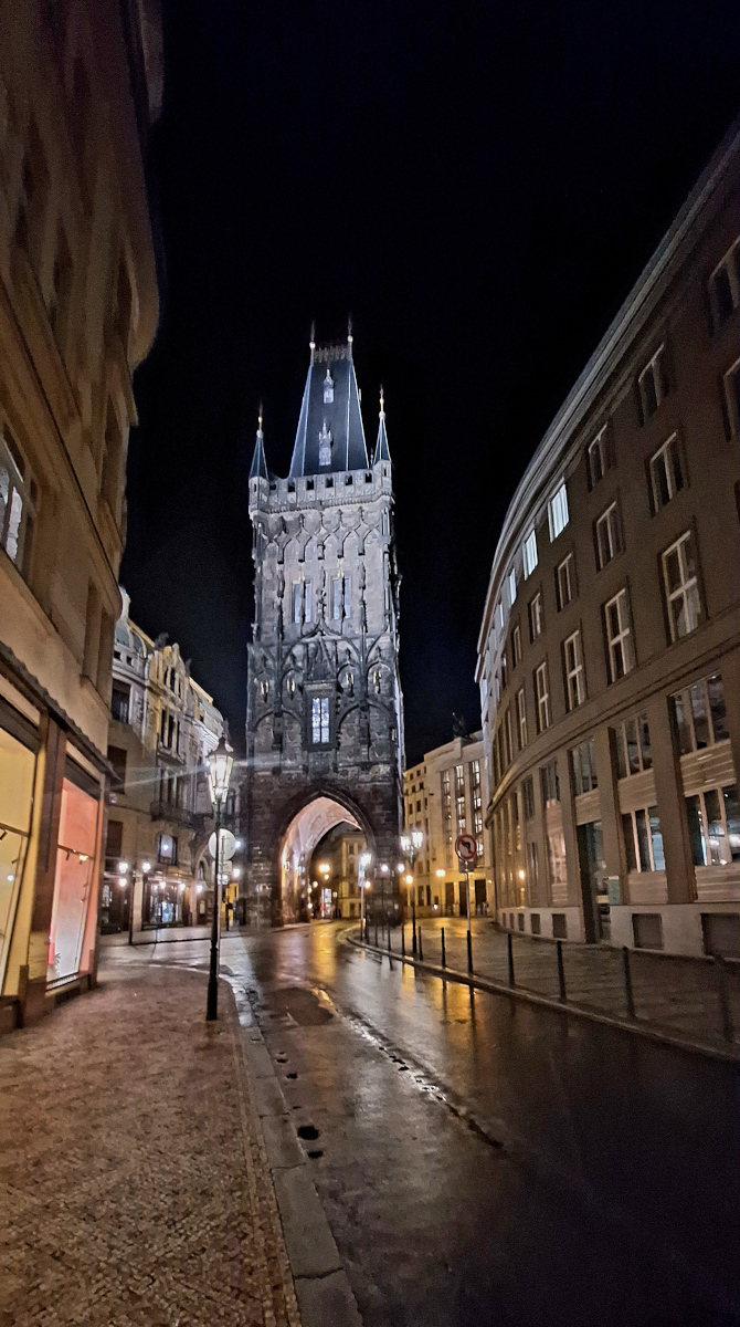 Ethereal towering structure in Prague illuminated by street lamps at night