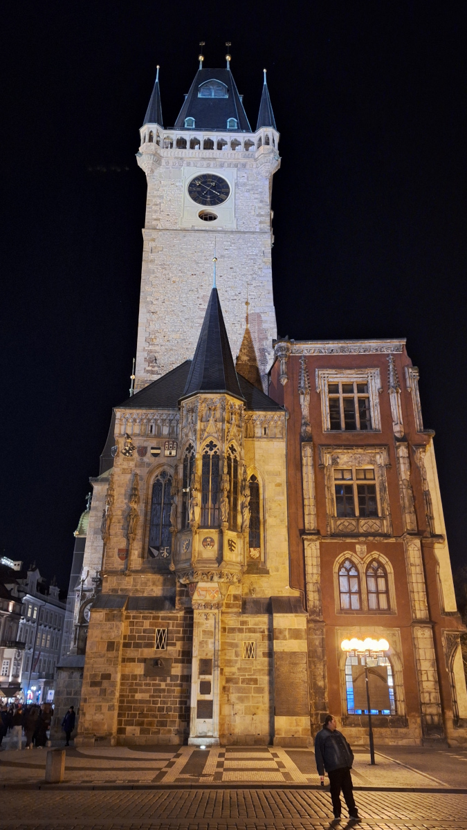 Building with spiral tower in Old Town Square, Prague, illuminated at night