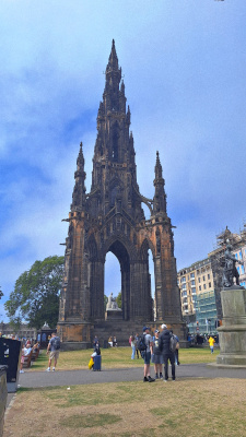 Scott Monument in Princes Street Gardens, surrounded by tourists enjoying the scenery