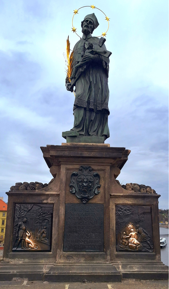Close-up of the Saint John of Nepomuk statue on Charles Bridge in Prague