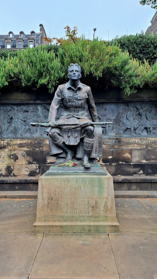 The Call Statue located in Princes Street Gardens, surrounded by greenery