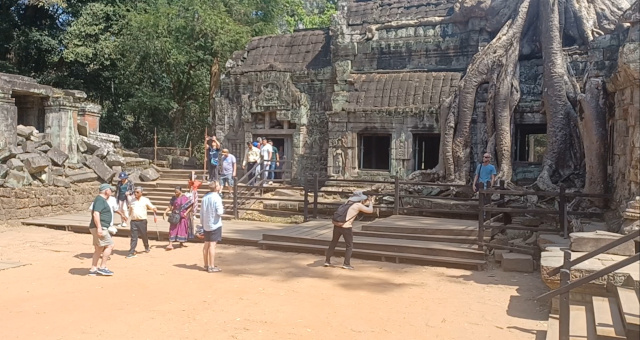 ourists at Angkor Thom Tourists posing for photographs at Angkor Thom in Cambodia