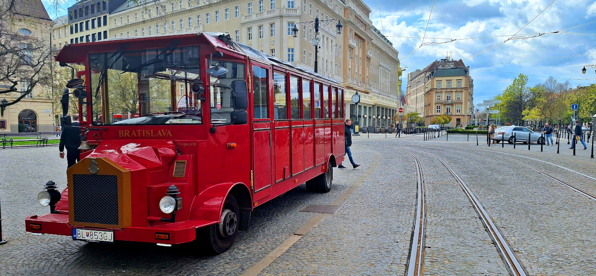 Vintage Red Bus and Architectural Beauty in Bratislava Vintage red bus in front of stunning architecture in Bratislava