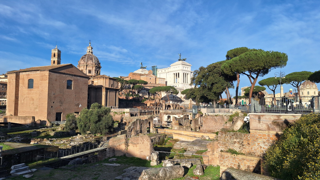 Ruins behind the statue of Julius Caesar in Rome, Italy Ruins behind the statue of Julius Caesar in Rome, Italy