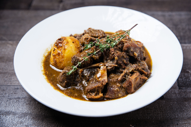 Oxtail Stew – Herb and Spice Delight in Trastevere, Rome Close-up of Oxtail Stew cooked in herbs and spices from a Trastevere restaurant