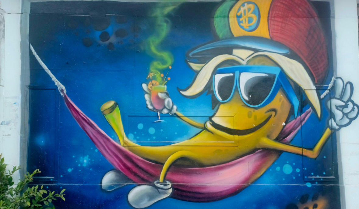 Street Art on the Banana Pancake Trail in Koh Phangan: Banana in a Hammock Street art featuring a banana with sunglasses reclining in a hammock