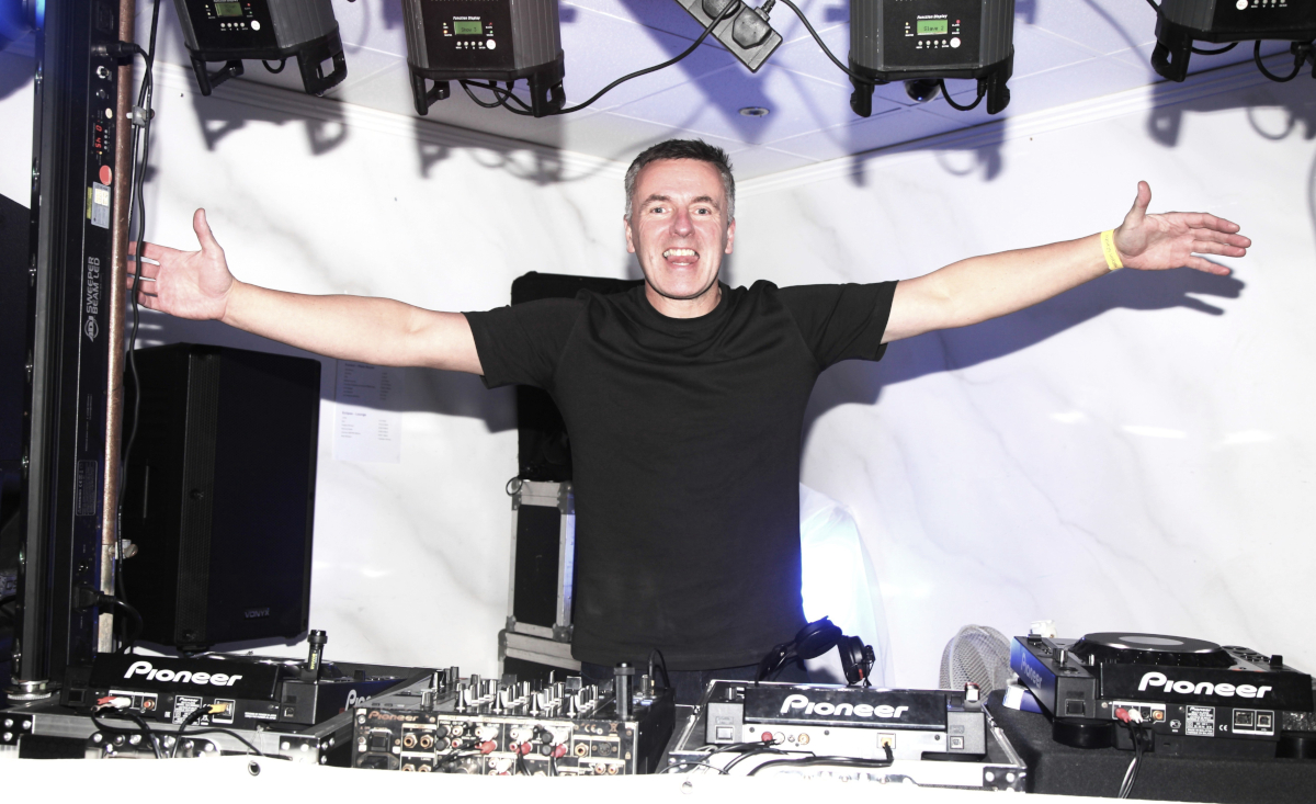 DJ Chris Keegan Welcomed by the Crowd with Open Arms DJ Chris Keegan holding out his arms, receiving a huge welcome from the crowd