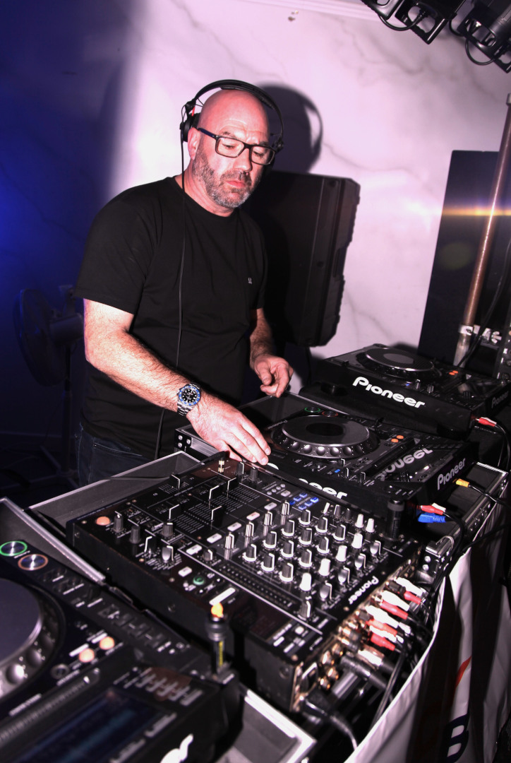 Three Pioneer Decks and Mixer in a Professional DJ Setup Professional DJ setup featuring three Pioneer decks and a Pioneer mixer