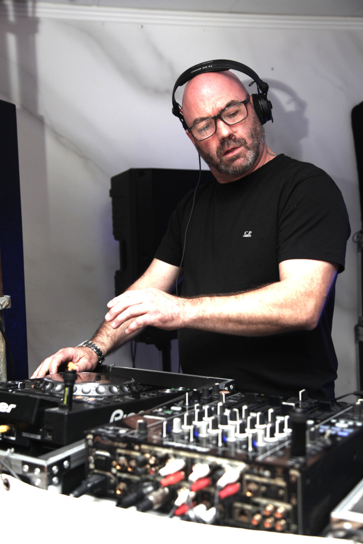 DJ Steven Conner Preparing for an Intense House Music Set DJ Steven Conner wearing headphones, cueing up a track during an intense house music set