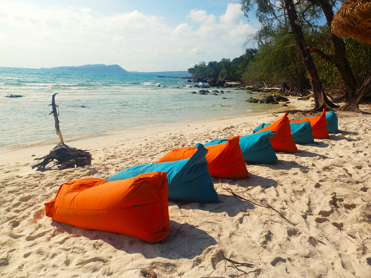 Colourful Beanbags on Koh Rong Beach Red and blue beanbags lined up on powdery sand with crystal clear waters and a blue sky in Koh Rong, Cambodia