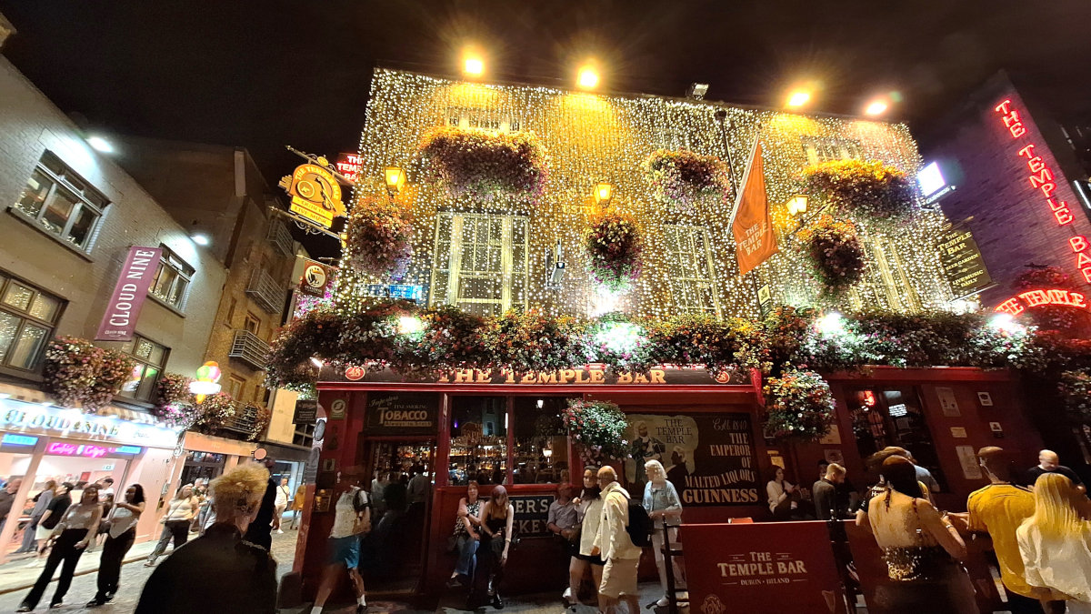 The Temple Bar at Night, Dublin, Ireland The Temple Bar in Dublin, Ireland, illuminated by LED lights at night with a bustling scene of people and tourists