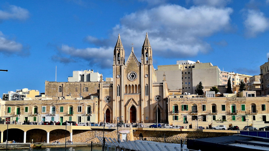 Scenic View of Sliema Cathedral from Spinola Bay View of the cathedral in Sliema, Malta, captured from Spinola Bay near St. Julian's