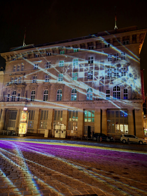 Colorful LED Illuminations of Vienna’s Architecture Vibrant night scene of Vienna's architecture illuminated by colorful LED lights, contrasting with the historic buildings.
