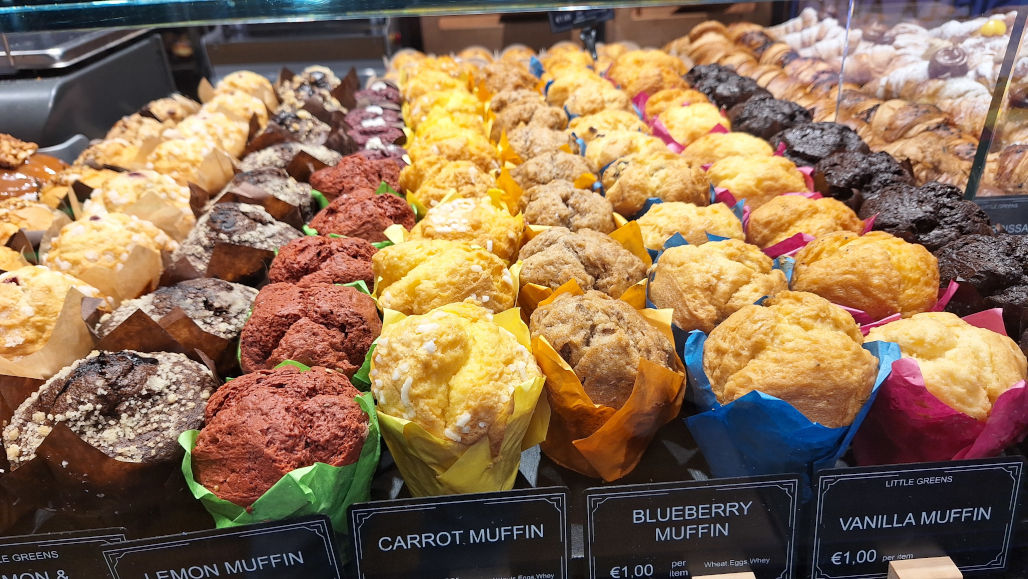 07-malta-bakery-counter Close-up of flavoured muffins from a Maltese bakery, including blueberry, carrot, lemon, vanilla, and more