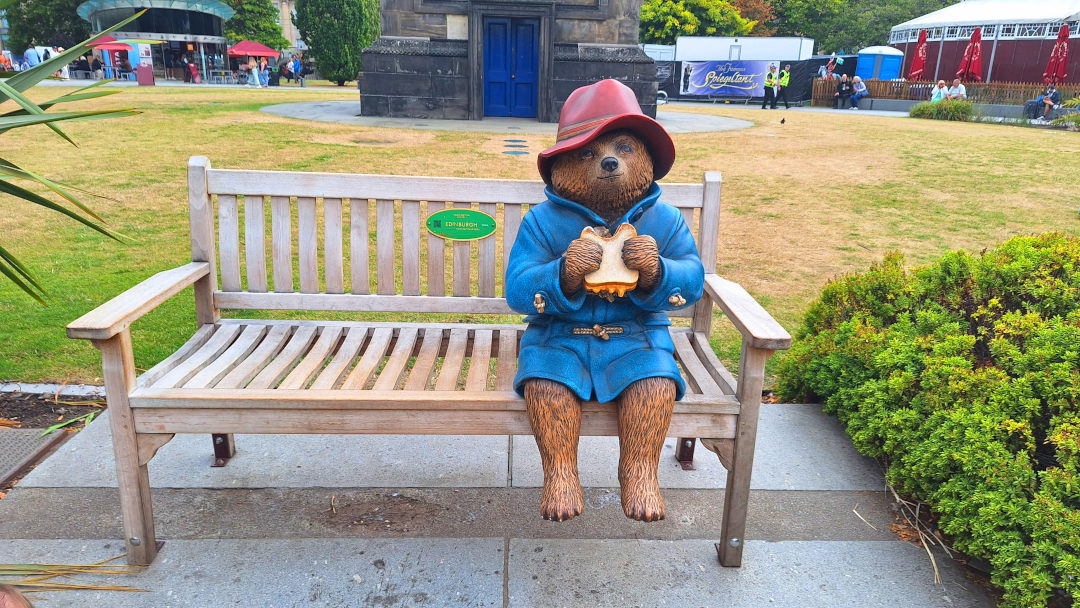 Paddington bear in Edinburgh Paddington bear sitting on a bench, enjoying a sandwich in Edinburgh.