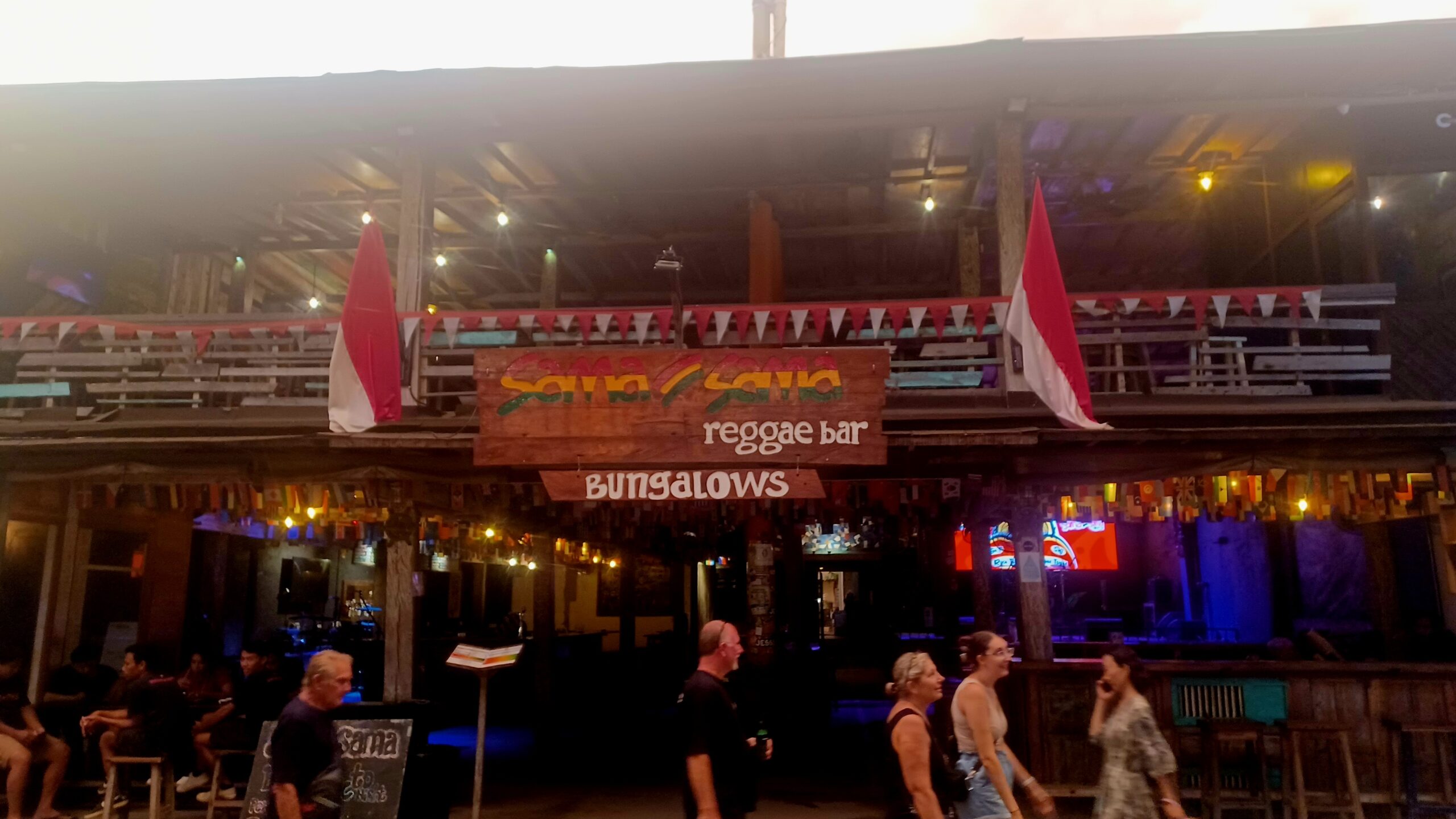 Vibrant Atmosphere at Sama Sama Reggae Bar, Gili Trawangan Exterior view of Sama Sama Reggae Bar on Gili Trawangan with many people enjoying sunshine and music outside