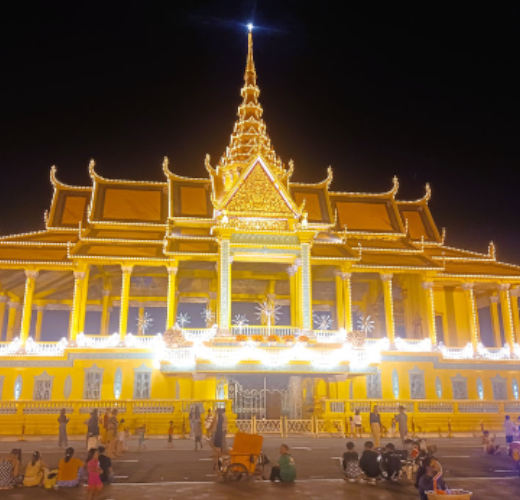 Golden Temple in Phnom Penh set against a night time sky.